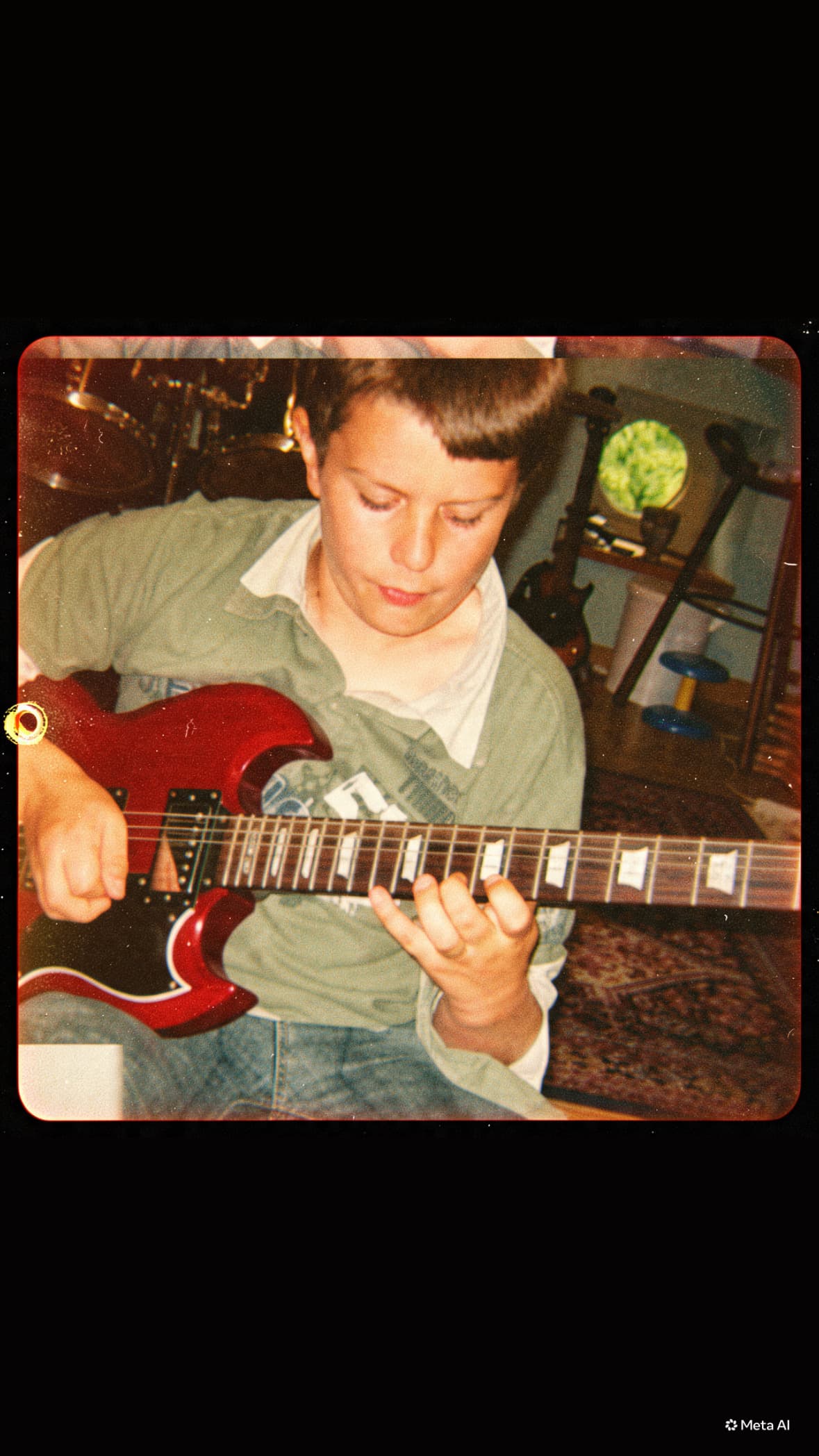 Sébastien as a child playing his red guitar